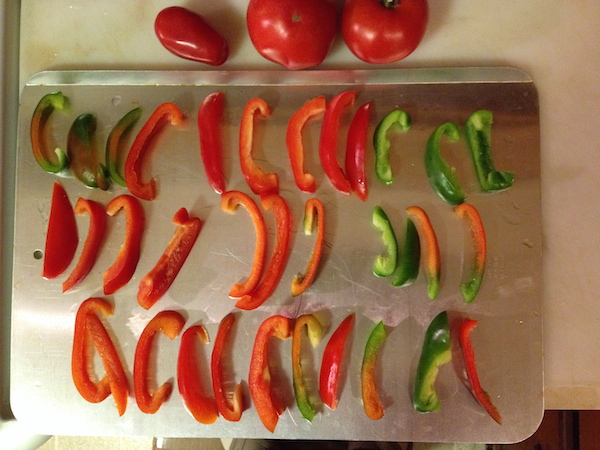 freeze peppers and peppers freezing (2 photos) Slice the peppers, place on a cookie sheet and freeze. When frozen, move peppers to a plastic bag and return to the freezer. Nothing could be easier. © Jo Ellen Meyers Sharp 