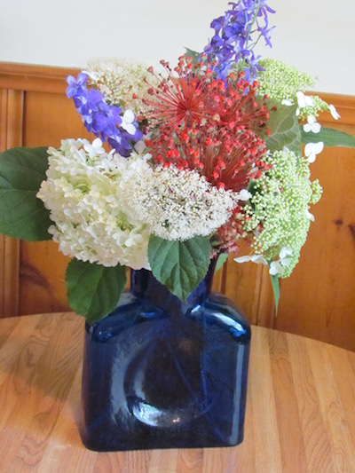 Annabelle and White Dome hydrangeas, blue larkspur and the seed heads of allium form a July Fourth bouquet of flowers cut fresh from the garden. © Jo Ellen Meyers Sharp 